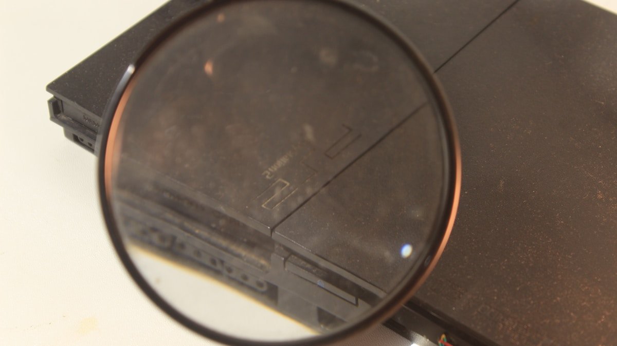 Console de jeu vidéo rétro sous une loupe.