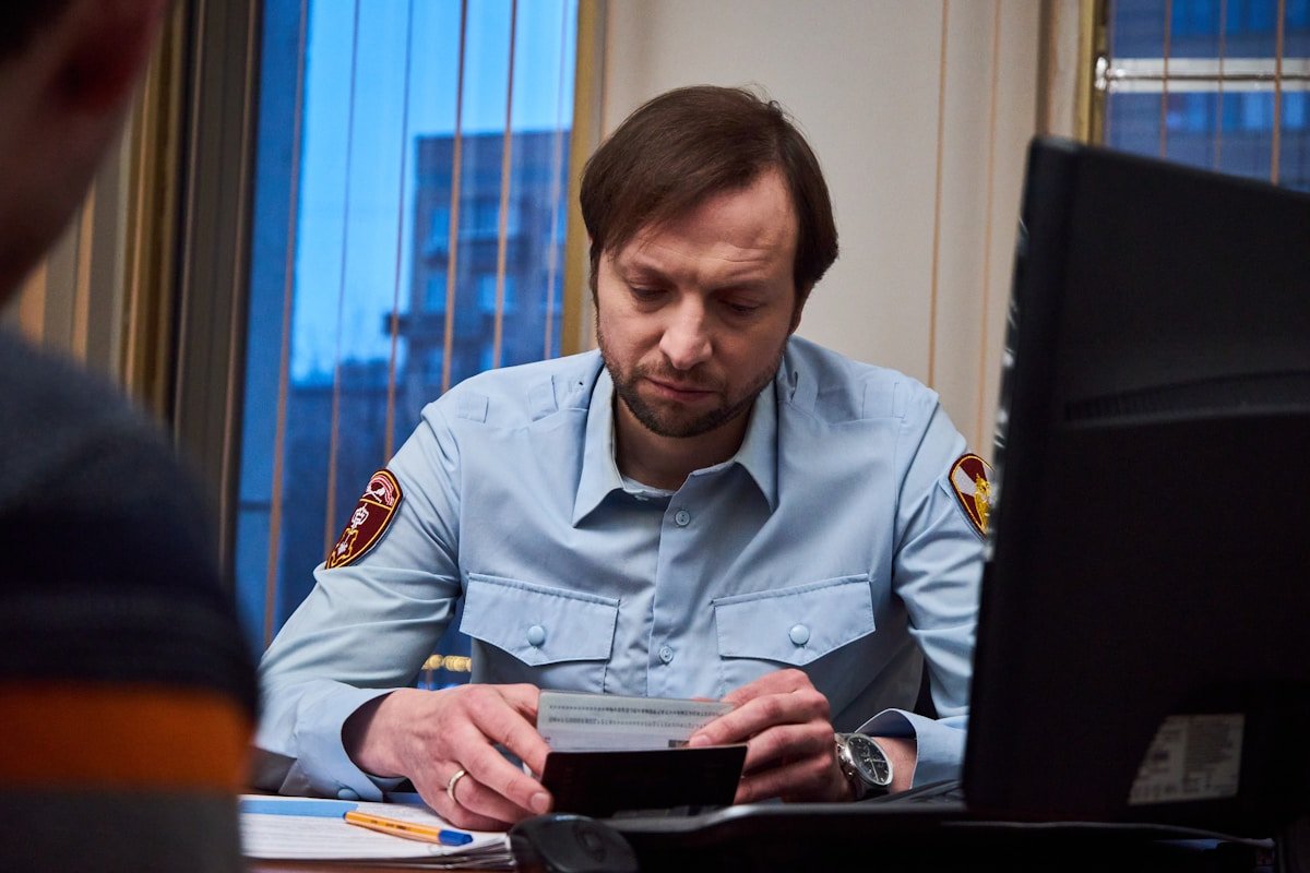 Un agent de sécurité assis à son bureau, concentré sur un document.